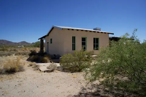 Solitary adobe house in a high-desert New Mexico landscape